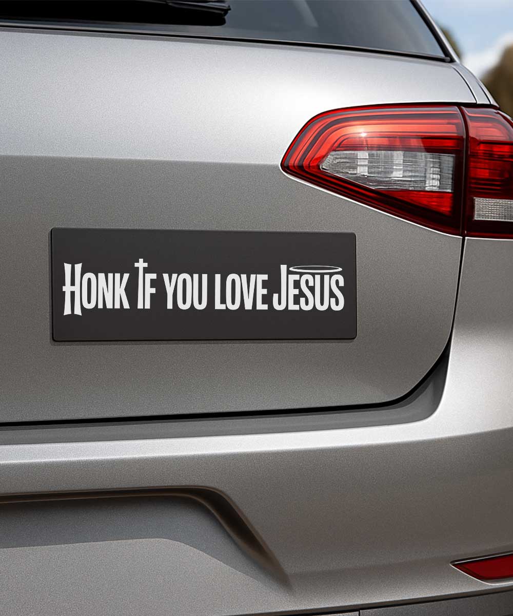Honk if you love Jesus Christian bumper sticker shown on a silver car bumper