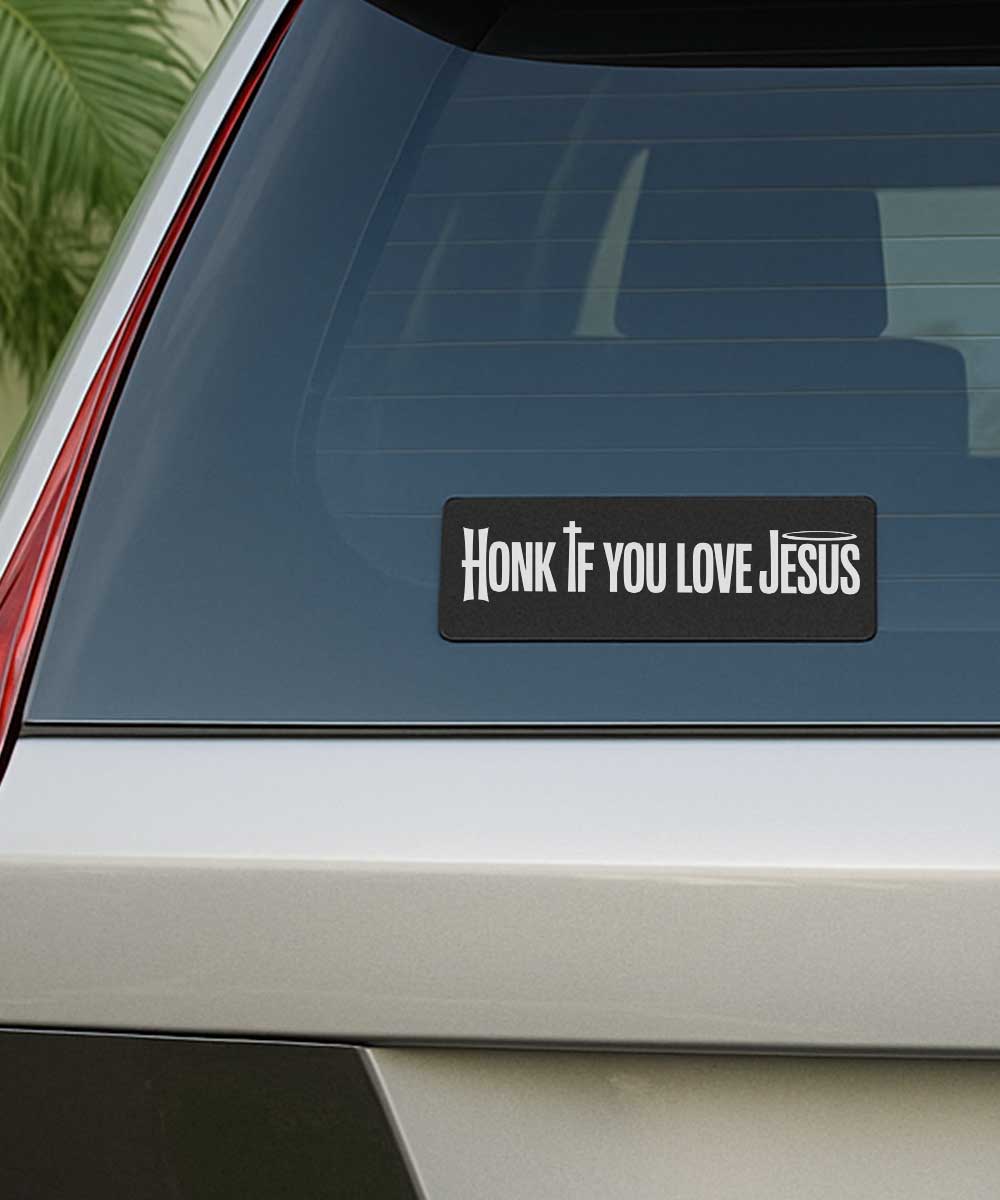 honk-if-you-love-jesus-bumper-sticker-on-rear-car-window Honk if you love Jesus bumper sticker on the rear glass window of a silver grey car