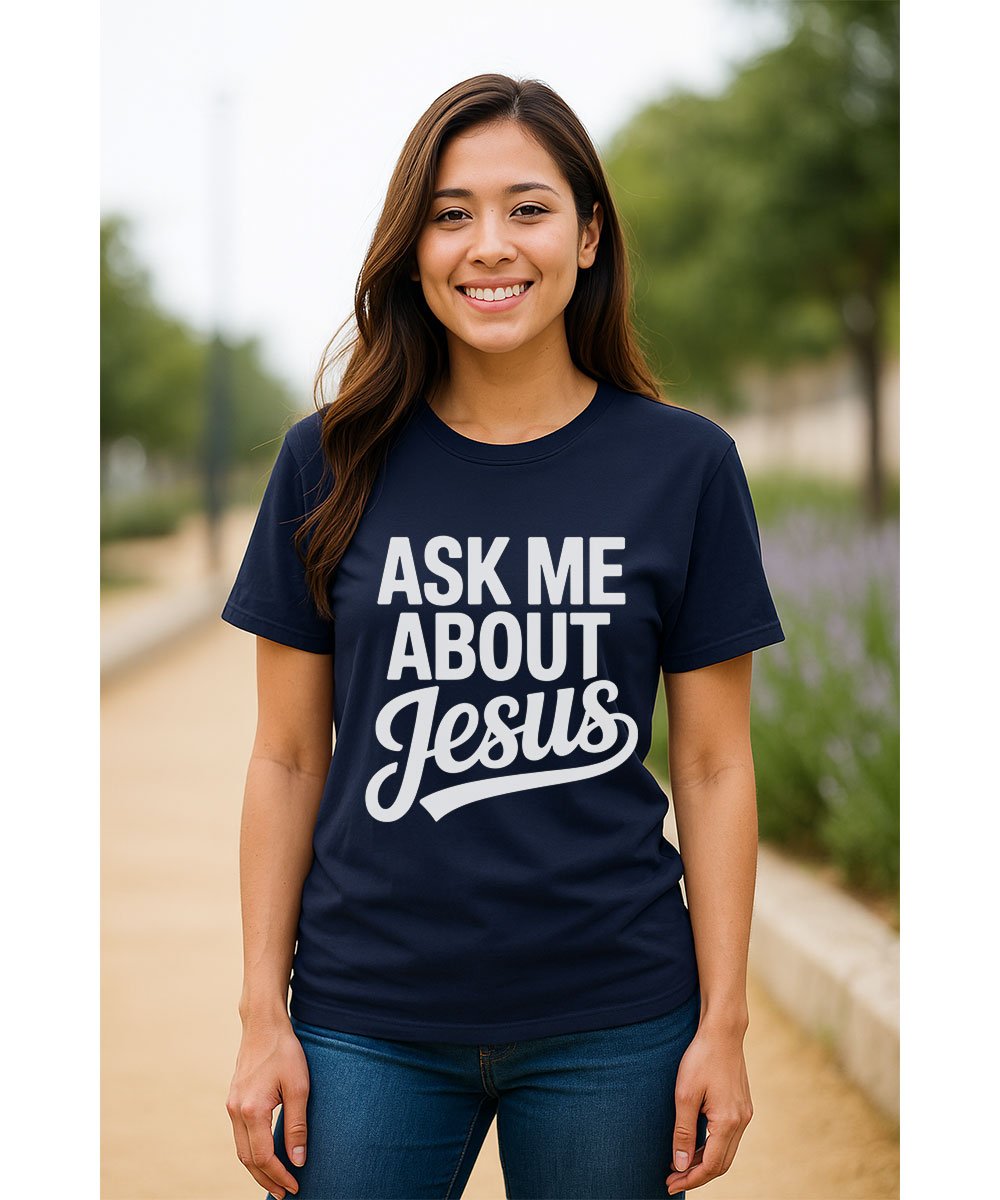 A smiling woman who appears to be of Hispanic or Latina heritage models the "Ask Me About Jesus Christian T-Shirt" outdoors.