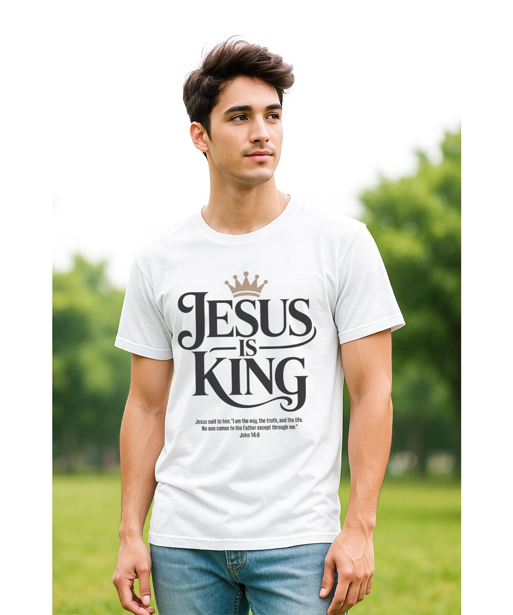 A young man who appears to be of Hispanic or South Asian heritage models the white "Jesus is King Christian T-Shirt" in a park.