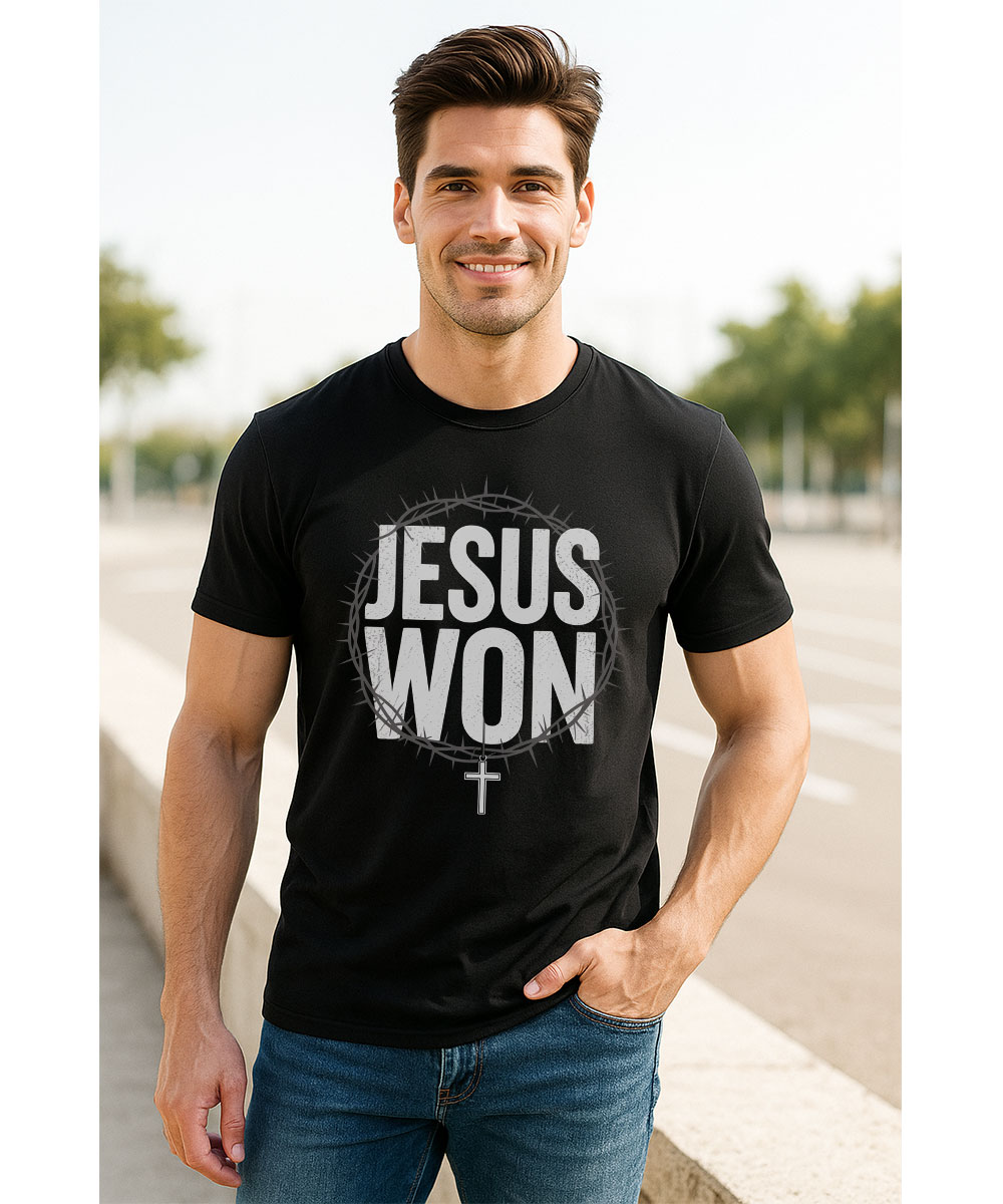 A smiling man who appears to be Caucasian models the black "Jesus Won Christian T-Shirt" outdoors.