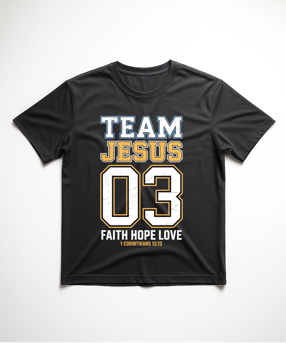 A black "Team Jesus T-Shirt" laid flat, featuring a varsity jersey design with the number 03 and the "Faith Hope Love" scripture from 1 Corinthians 13.
