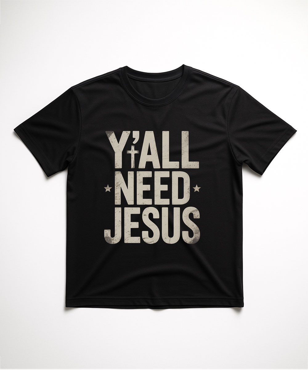A black "Y'all Need Jesus Christian T-Shirt" laid flat, featuring a humorous message in a distressed, vintage block font.
