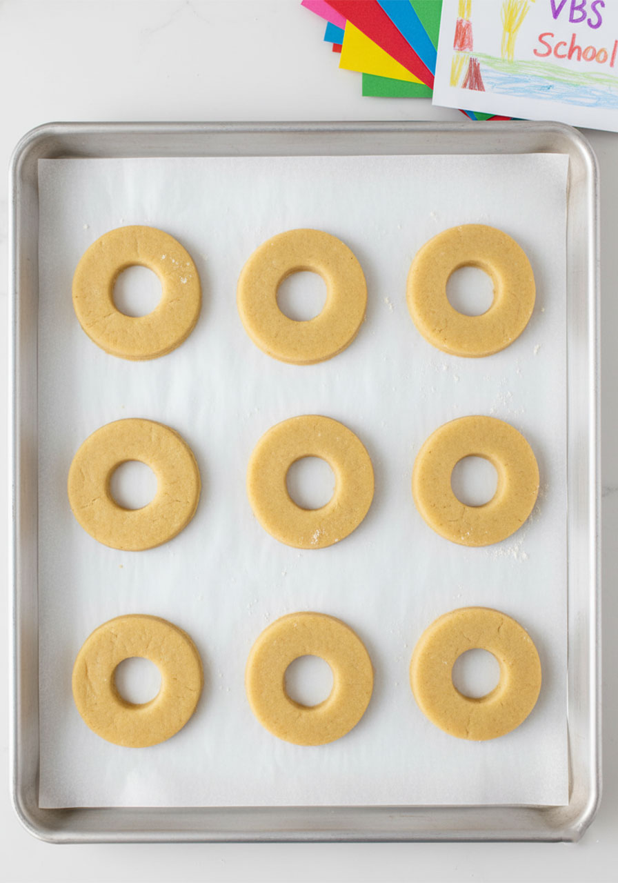Raw gluten-free almond flour Samoa cookie rings on parchment-lined baking sheet ready to bake at 250 degrees