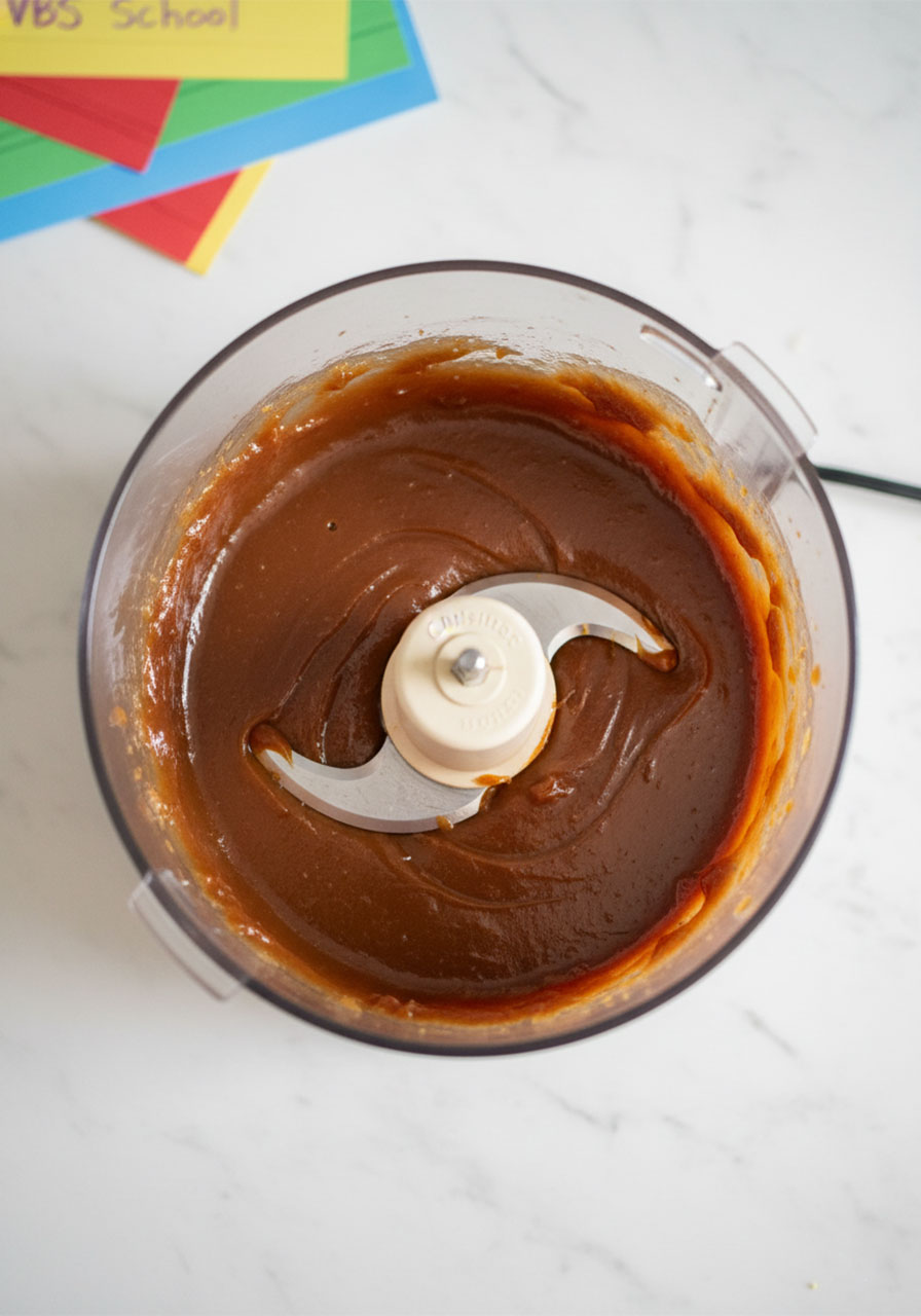 Smooth glossy one-ingredient date caramel blended in food processor for healthy vegan Samoa cookie recipe